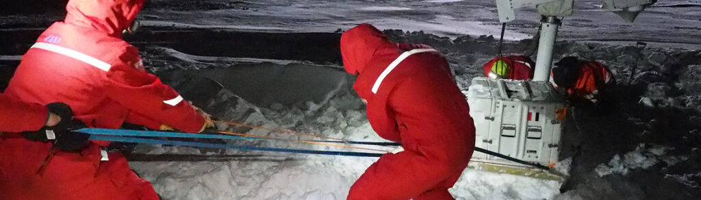Arctic rearchers installing equipment in harsh conditions