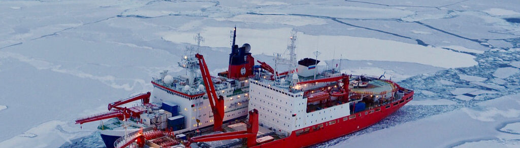 Two research vessels side by side in the Arctic Ocean sea ice