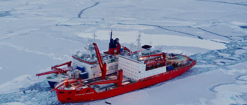 Two research vessels side by side in the Arctic Ocean sea ice