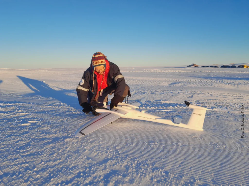 researcher preparing drone for flight over the Antarctic ice shield